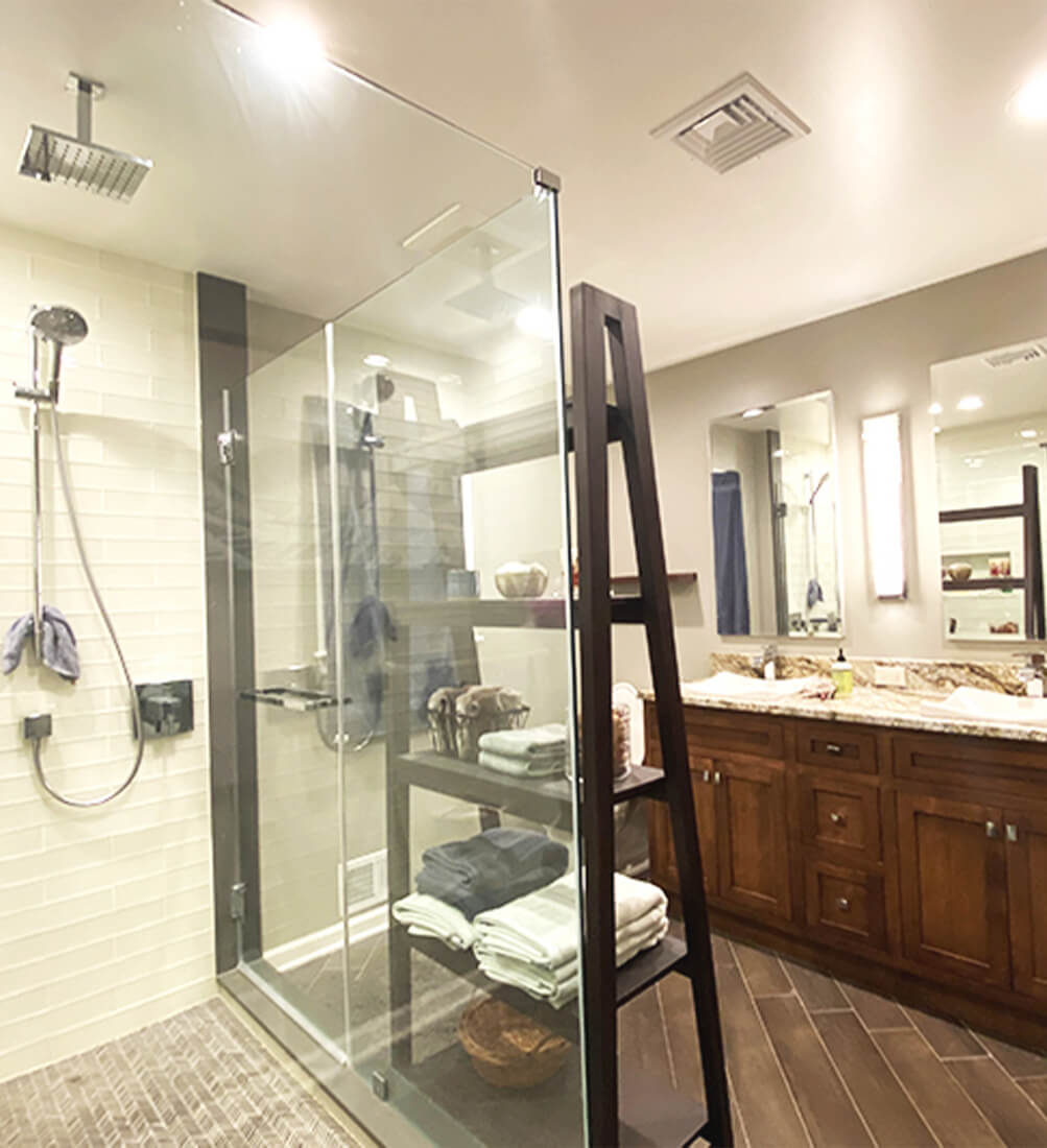 Beige Bathroom with Tiled Shower and Glass Shower Walls 