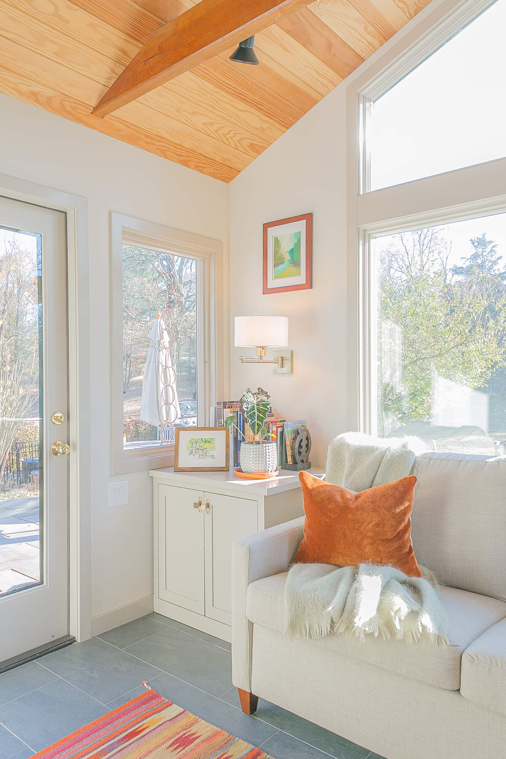 Beautiful side table next to sofa in this sunroom remodel