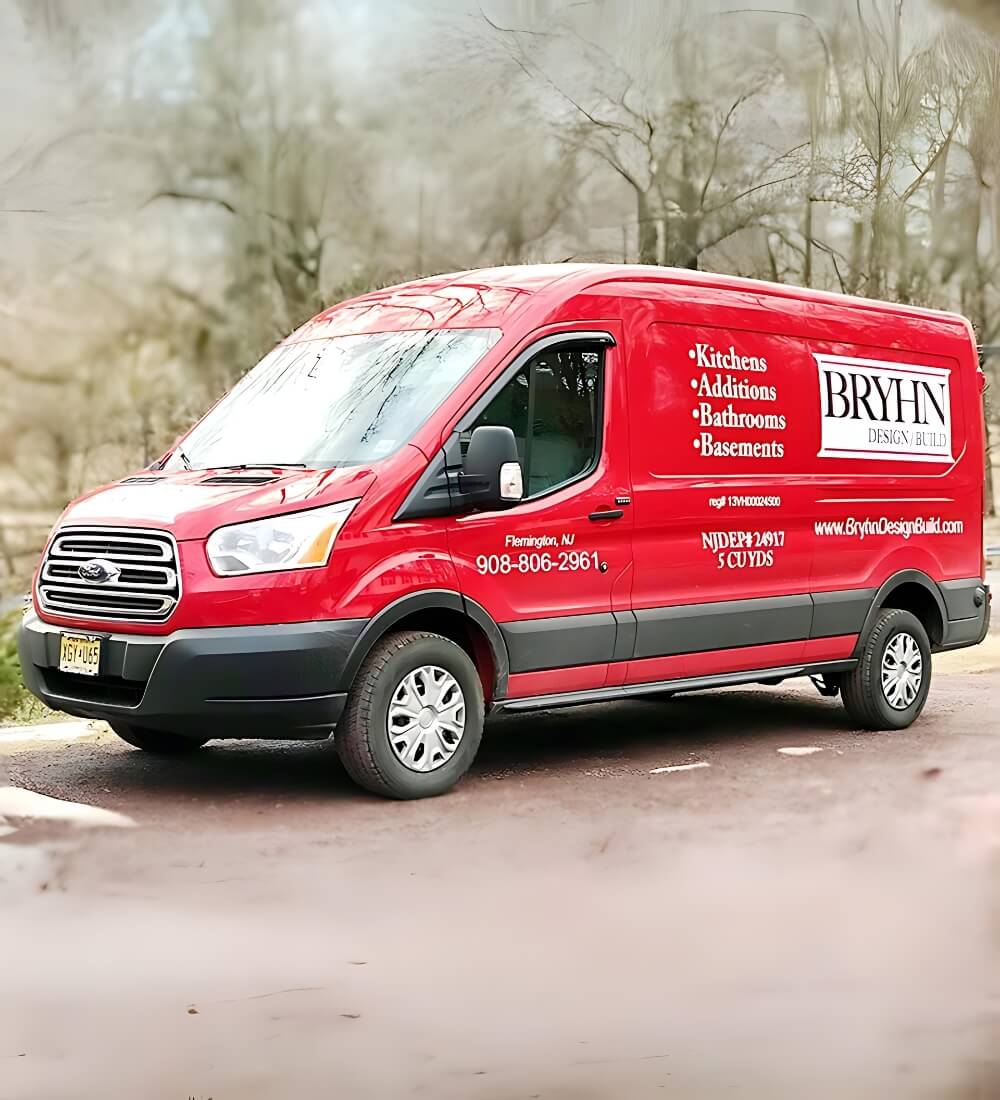 Red Bryhn Design/Build service van showcasing services like kitchens, additions, bathrooms, and basements, parked in Flemington, NJ.