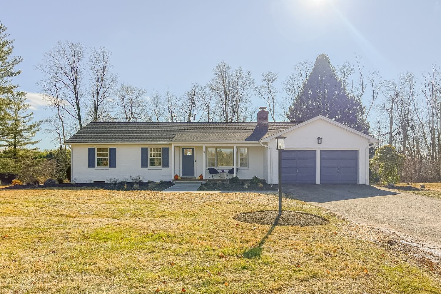 Exterior home transformation with fresh white paint and modern landscaping in Rosemont, NJ