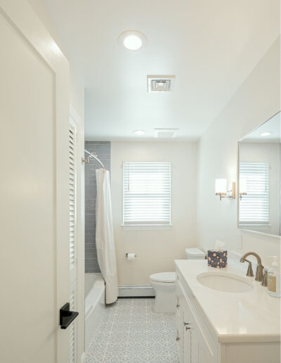 Modern bathroom with patterned tile flooring and gray tiled shower in Rosemont, NJ remodel.