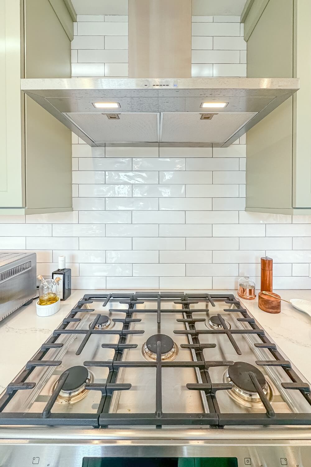 Stainless steel gas cooktop with white subway tile backsplash in remodeled kitchen, Rosemont, NJ.